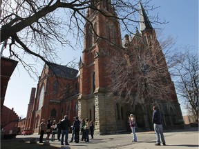 A tour group takes in the grounds at Ste. Anne's Church in Detroit.