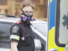 WINDSOR, ONT:. MARCH 19, 2020 -- EMS paramedics put on protective garb while responding to a patient who screened positive for COVID-19 at a home in South Windsor, Friday, March 20, 2020.