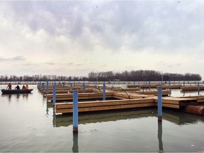 Construction workers are shown at the Lakeview Park Marina's new $5.5-million floating dock system project in Windsor on March 26, 2020. The city has made a claim to its insurance company after the old docks were severely damaged by rising lake levels last year.