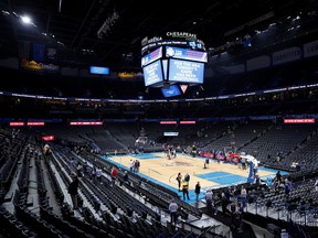 Fan leave after an announcement that the Oklahoma City Thunder vs. Utah Jazz game is canceled just before the tip off at Chesapeake Energy Arena.