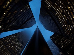FILE PHOTO: Buildings are seen in the financial district in Toronto, January 28, 2013.   Moody's Investors Service has cut the ratings of six Canadian financial institutions, including the previously "Aaa" rated Toronto-Dominion Bank, due to concerns about rising consumer debt and high housing prices. TD, the only publicly traded bank that still carried Moody's top rating, was downgraded, along with Bank of Nova Scotia , Canadian Imperial Bank of Commerce, Bank of Montreal, National Bank of Canada and Caisse Central Desjardins, Canada's largest association of credit unions, Moody's said on Monday.