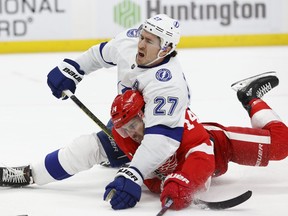 Tampa Bay Lightning defenceman Ryan McDonagh (27) and Detroit Red Wings centre Robby Fabbri (14) go to the ice in overtime at Little Caesars Arena, March 8, 2020. Fabbri scored in the shootout.