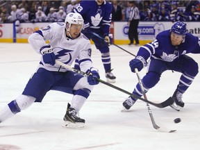 Tampa Bay Lightning forward Yanni Gourde (37) backhands the puck against Toronto Maple Leafs defenseman Morgan Rielly (44) during the third period at Scotiabank Arena. Toronto defeated Tampa Bay.