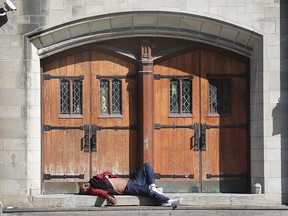WINDSOR, ON. OCTOBER 8, 2019. --  A homeless man sleeps in front of The Downtown Mission on Tuesday, October 8, 2019. For files. (DAN JANISSE/The Windsor Star) homeless, poverty, downtown