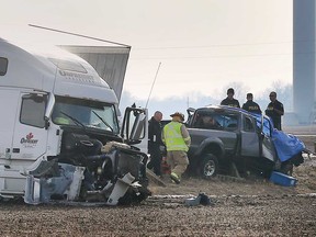 Emergency personnel examine the wreckage of a tractor trailer and a pickup truck that collided head-on in the Lakeshore area on March 2, 2020. The pickup truck driver was pronounced dead at the scene.