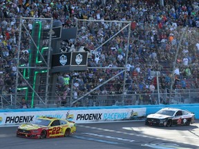 Joey Logano, driver of the #22 Shell Pennzoil Ford, crosses the finish line to win the NASCAR Cup Series FanShield 500 at Phoenix Raceway in Avondale, Ariz., on March 8, 2020.