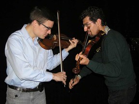 Eliot Heaton, concert master of the Michigan Opera Theatre, faces off with violinist Henrik
Karapetyan. Members of the Michigan Opera  Theatre will perform excerpts of the modern opera Champion at the Border City Boxing Club in Windsor on Friday, March 6, 2020.