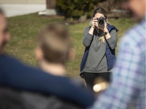 JessicaTanchioni, a local photographer, takes family portraits of the McLean family while in isolation, Wednesday, March 25, 2020.