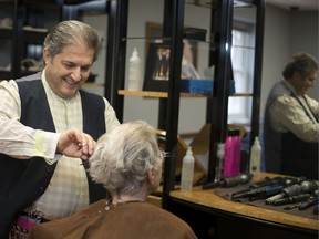 Antoine Greige, owner of Windsor's Antoine Greige Salon, works with a client on Thursday, March 19, 2020. To ensure the safety of clients, the salon is taking fewer clients at any given time.