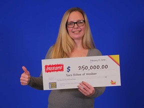 Sara Kehoe, 39, of Windsor, holds the $250,000 prize cheque she received with a winning INSTANT scratch game in February 2020.