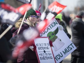 Elementary and secondary school teachers picket in front of Windsor's Kennedy Collegiate Institute on Feb. 21, 2020.