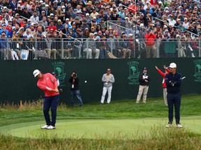 Gary Woodland chips onto the 17th green as Justin Rose looks on during the final round of the 2019 U.S. Open at Pebble Beach Golf Links, in Pebble Beach, Calif., June 16, 2019.