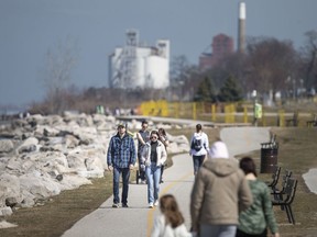 People get outside to enjoy the spring weather along Windsor's water front, Wednesday, March 25, 2020.