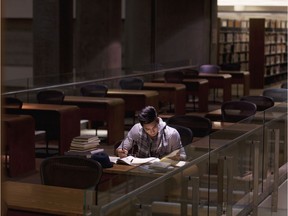 A university student studies in a library.