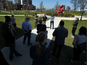 Greg Atkinson, Kevin Alexander and Laura Diotte (left to right) lead a group on a Jane's Walk tour in downtown Windsor on Saturday, May 2, 2015.