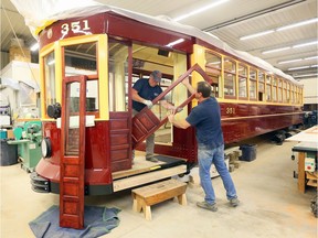 Blenheim, Ontario. September 18, 2019.  RM Restorations technicians Serge Legare, left, and Jamie Bourdeau install sliding doors made of cherrywood on Windsor's Streetcar No. 351 Wednesday. Nearing completion, Streetcar No. 351 will be a unique showpiece for the region due to the workmanship and fine details of the rebuild. (NICK BRANCACCIO/Windsor Star) 2019WindsorPOY