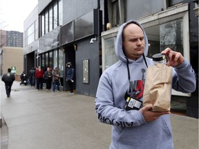 A customer departs J. Supply Co. in downtown Windsor on March 28, 2020, the opening day of Windsor's first legal retail pot shop. Ontario's cannabis retailers can reopen but only for online purchases and curbside pickup or home delivery.