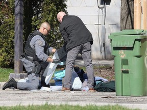 Windsor police investigators and members of the Emergency Services Unit collect evidence from the premises of the Motel 6 at 2000 Huron Church Rd. on April 2, 2020, in relation to a fatal shooting in the 2200 block of Northway Avenue.