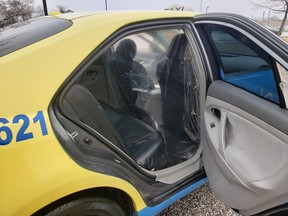 A temporary partition is seen in the back of a Veteran Cab in Windsor.