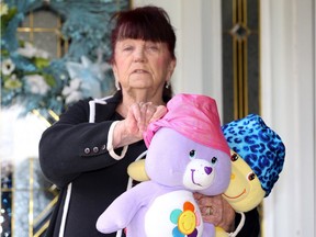 Marilyn Sbrocca displays her handmade nurses' caps at her LaSalle home Sunday. In photo, Sbrocca shows how the lycra caps are reversible and can be easily washed.