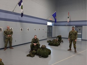 Keeping proper physical distance, members of The Essex and Kent Scottish Regiment prepare on April 6, 2020, to move from Windsor's Major F.A. Tilston Armoury to CFB Borden near Barrie in support of Operation LASER, the Canadian Armed Forces' response to the worldwide pandemic situation.
