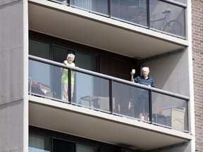 Windsor, Ontario. April14, 2020.  Six floors up, Doris Dupuis, 91, and her husband Jerry Dupuis, 88, enjoy a cup of coffee on their balcony Tuesday.  Jerry Dupuis wants to continue social distancing and disapproves of group gatherings at his apartment complex on Riverside Drive East. See story.