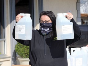 Clean hands. BASF Canada responsible care co-ordinator Erika Harris holds 5L bottles of hand sanitizer during a delivery of 25 cases to the City of Windsor on Tuesday, April 28, 2020. It's the first 500-litre shipment of an eventual 11,000-litre donation by the company.