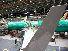 (FILES) In this file photo taken on March 27, 2019, employees work on Boeing 737 MAX airplanes at the Boeing Renton Factory in Renton, Washington. - Boeing unveiled a voluntary worker layoff program on April 2, 2020,, telling employees that it hoped to avoid "other workforce actions" as the aviation industry reels from the coronavirus crisis. The initiative, announced by Boeing Chief Executive David Calhoun, that such belt-tightening was needed amid the hit to the industry caused by the pandemic.