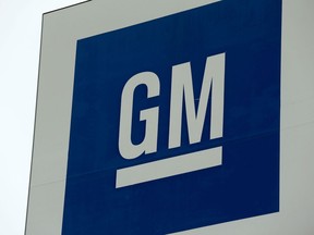 (FILES) In this file photo taken on January 27, 2020 a sign with the General Motors (GM) logo is seen outside the GM Detroit- Hamtramck assembly plant in Detroit, Michigan. - General Motors announced April 27, 2020 that it will suspend its dividend and halt share repurchases as it conserves cash amid a broad economic slowdown expected to weigh on auto purchases. GM said it had also extended a $3.6 billion bank credit facility through April 2022 to build more liquidity capacity.