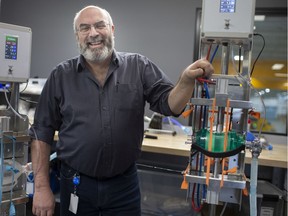 CenterLine vice-president, Larry Koscielski, stands next to a pair of hands-free Ambu bag actuators, Tuesday, April 21, 2020.