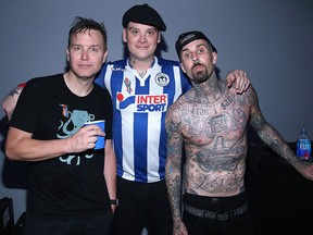 (L-R) Musicians Mark Hoppus, Matt Skiba and Travis Barker of Blink-182 backstage as Bethesda Softworks shows off new video game experiences at its E3 Showcase and BE3 Plus event at the LA Hangar in Los Angeles, ahead of the Electronic Entertainment Expo (E3) happening at the Los Angeles Convention Center, on June 12, 2016, in Los Angeles.