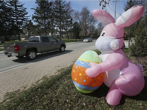 An inflatable Easter bunny sporting a surgical mask is shown along Riverside Drive East in Windsor on Saturday, April 11, 2020.