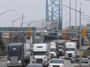 More workers, including in the trucking sector, are seeking voluntary layoffs due to stress and fears over CIVID-19. Here, trucks are shown exiting the Ambassador Bridge in Windsor on March 19, 2020.