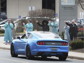 A large group of local classic car owners paraded by the Windsor Regional Hospital Met and Ouellette campuses on Thursday, April 16, 2020 in an effort to thank front-line health care workers. One of the participants cruises by the Ouellette campus during the event.