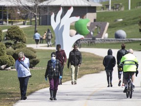 People stroll through the Windsor Sculpture Park on the riverfront on April 2, 2020.