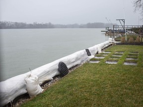 A protective row of sandbags is shown guarding an East Riverside home from high water levels shown Tuesday, April 7, 2020.