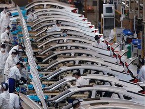 COVID-19 will change the auto sector and supply chains, says the new CEO of Honda Canada. Shown here on April 8, 2020, are Honda employees at a factory reopened after lockdown measures in Wuhan, the capital of Hubei province and China's epicentre of the novel coronavirus disease (COVID-19) outbreak.