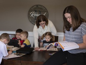 "Hanging in there." Nicole Renaud is shown on Monday, April 6, 2020, helping her kids with school work: Charlie, 6, (left), Christopher, 9, Matthew, 7, Allison, 4, and Bella Cowan Rivera, at their home in Lakeshore. The new reality for millions in Ontario during COVID-19 is learning at home.