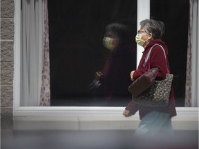 A staff member walks into Country Village Homes - Woodslee, a long-term care facility, Tuesday, April 14, 2020.