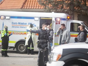 Windsor police, EMS paramedics and Windsor firefighters attend the scene of a crash at a Howard Johnson Hotel parking lot in Windsor on Tuesday April 7, 2020.