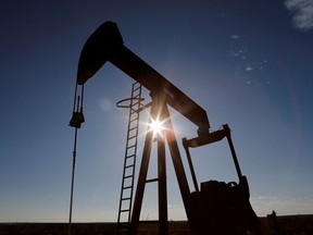 The sun is seen behind a crude oil pump jack in the Permian Basin in Loving County, Texas, Nov. 22, 2019.