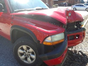 Front end damage to a red Dodge Ram pickup truck that struck a building, a hydro pole, and a parked vehicle in Leamington on April 6, 2020.