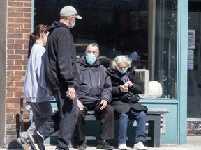 Toronto residents wear masks while in public on Lakeshore Boulevard on April 2, 2020.