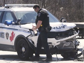 A Windsor Police officer is shown at an accident involving a department SUV and a car on Thursday, April 2, 2020 at the intersection of Central Ave. and Grand Marais Rd. East. The accident occurred at approximately 10:30 a.m. Injuries were not life-threatening.