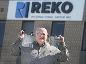 Dave Romanello, director of tooling at REKO International in Lakeshore displays plastic shields on Thursday, April 2, 2020, that the company is making for front line health care workers.