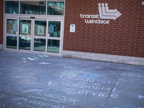"Transit is an essential service." Messages written in chalk protesting the decision to shut down Transit Windsor service for two weeks, as part of the battle against coronavirus, are shown Monday on the pavement surrounding the downtown transit terminal.