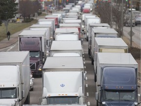Trucks are shown in this Nov. 28, 2018, file photo lined up along northbound Huron Church as they wait to cross the Ambassador Bridge.