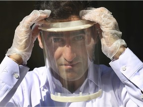 University of Windsor engineering student Hamed Kalami displays an adjustable face shield on Friday, April 3, 2020. A group of researchers at the faculty of engineering have designed face masks and hands-free attachments for door handles, and are making parts for face shields and ventilators to help combat the spread of the COVID-19 virus.