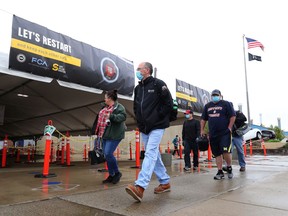 United Auto Workers members leave the Fiat Chrysler Automobiles Warren Truck Plant after the first work shift on May 18, 2020 in Warren, Michigan. Fiat Chrysler along with rivals Ford and General Motors Co., restarted the assembly lines on Monday after several week of inactivity due to the COVID-19 pandemic.