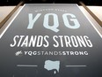 YQG Stands Strong poster in window of Tourism Windsor Essex Pelee Island Wednesday.